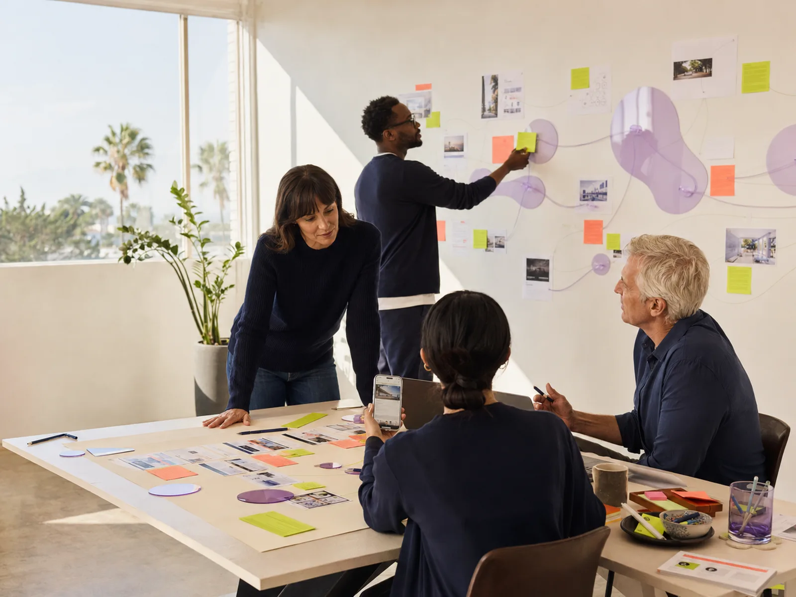 Search strategists mapping website pages and a customer journey in a bright Southern California workshop